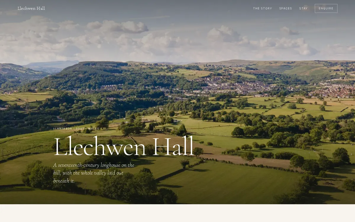 Llechwen Hall spec build — hero with the valley laid out beneath the hall